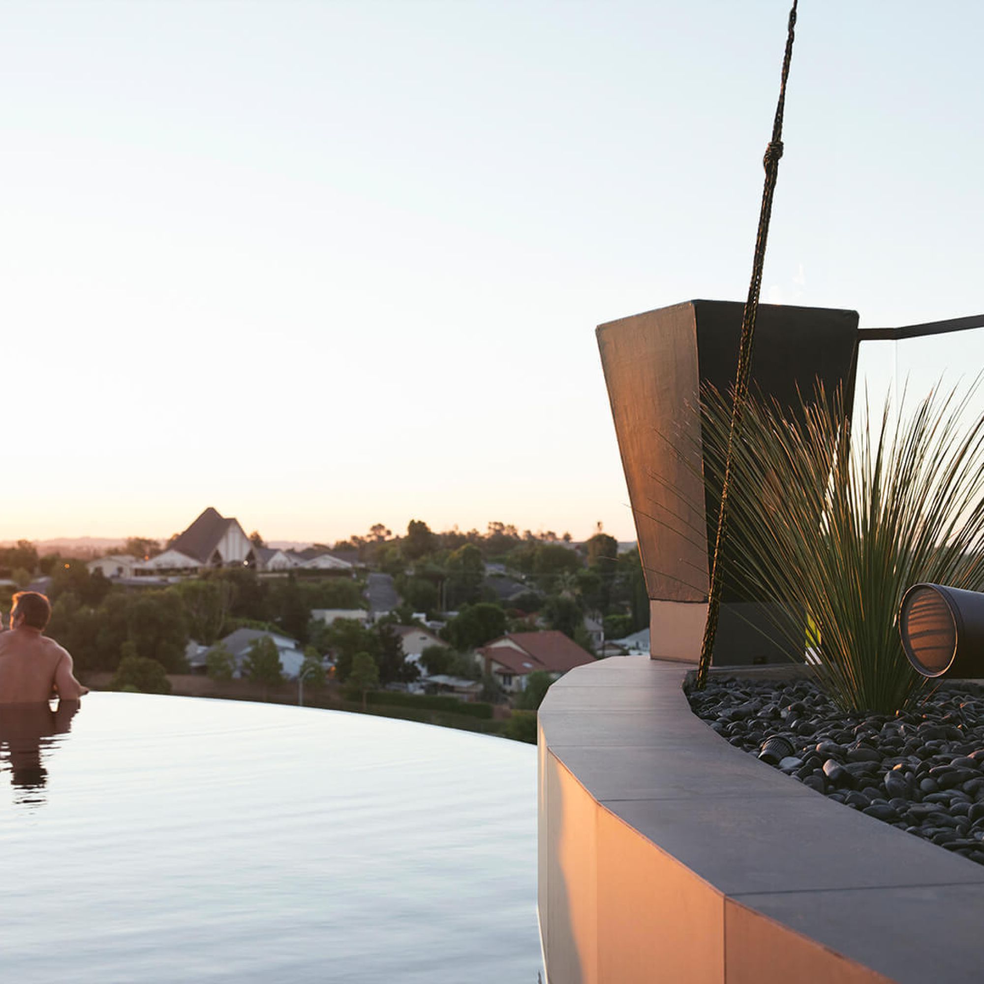 Man and woman in a pool with a speaker on the right side